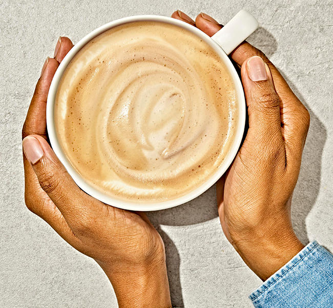 Hands holding a latte